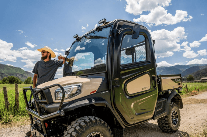 Man standing alongside RTV