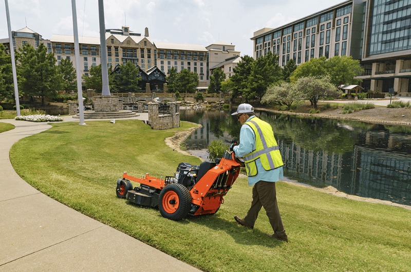 Landscaper mowing commercial lawn