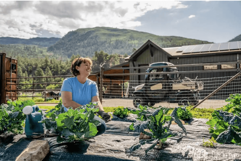 Woman at her garden with a RTV in the back