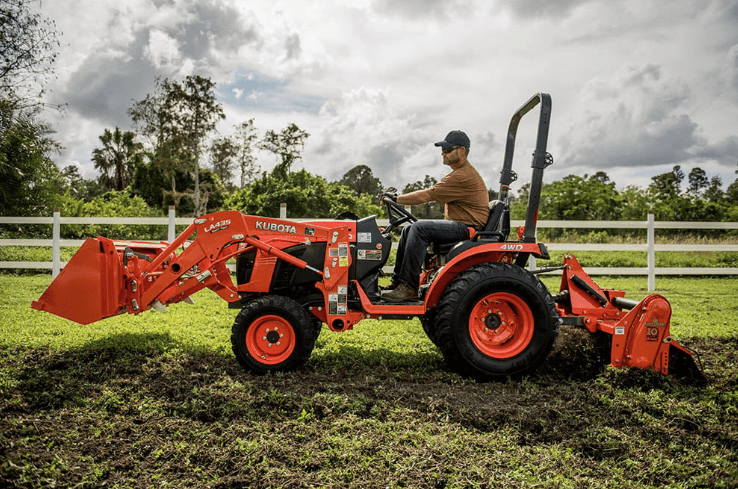 Man using a tiller attachment on his tractor
