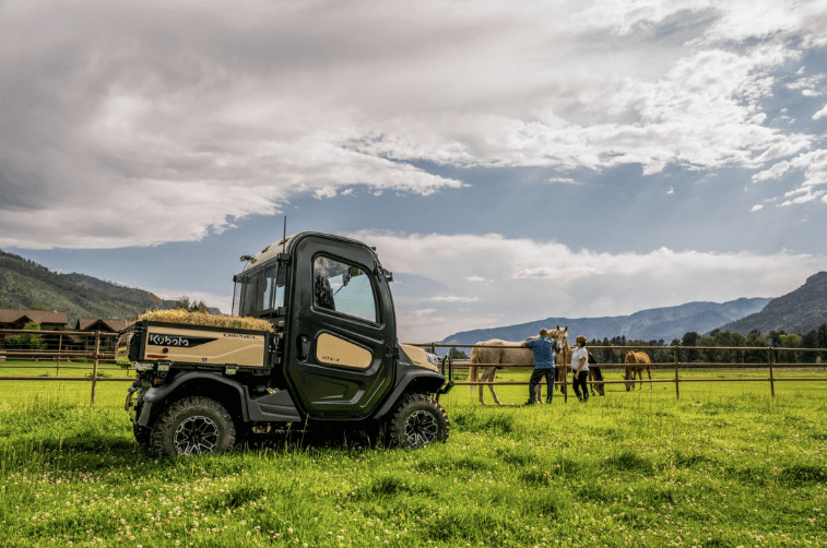 RTV out in a field with horses
