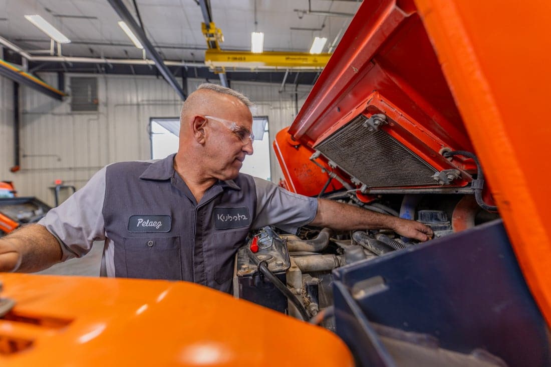 Kubota technician working on equipment