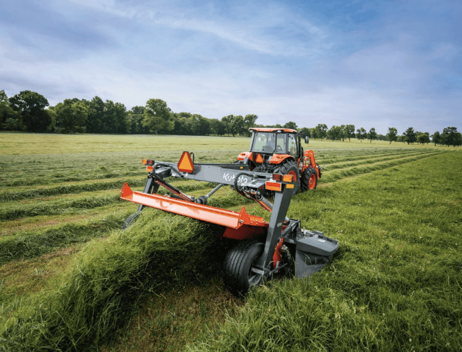 Kubota using a Disc Mower