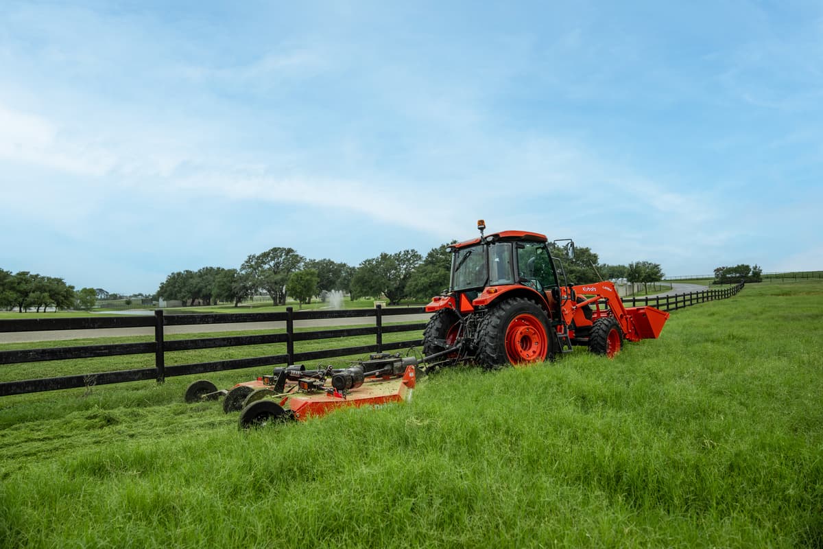Kubota M4 pulling a mower
